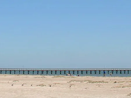 Sandy bay beach and a long fishing pier at Port O'Connor